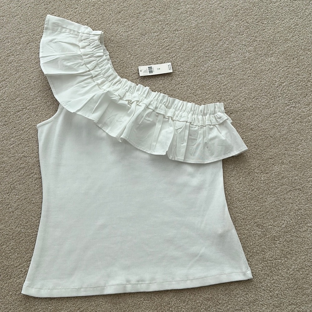 1 shoulder white ruffle shirt. By porridge. New with tags. Ribbed texture body.